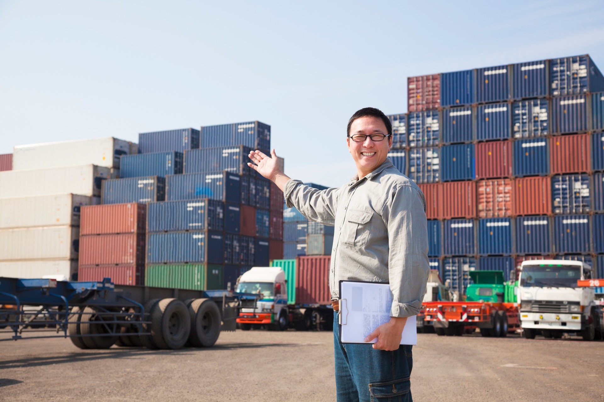 happy man in front of container truck